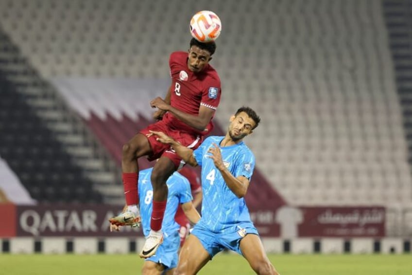 Qatar midfielder Ibrahim Al-Hassan leaps above India defender Anwar Ali