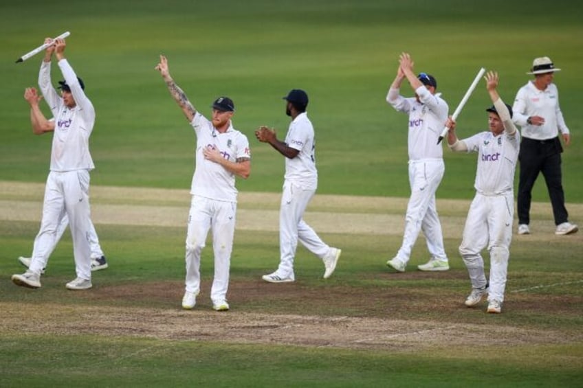 Captain Ben Stokes (2L) leads England's victory celebrations