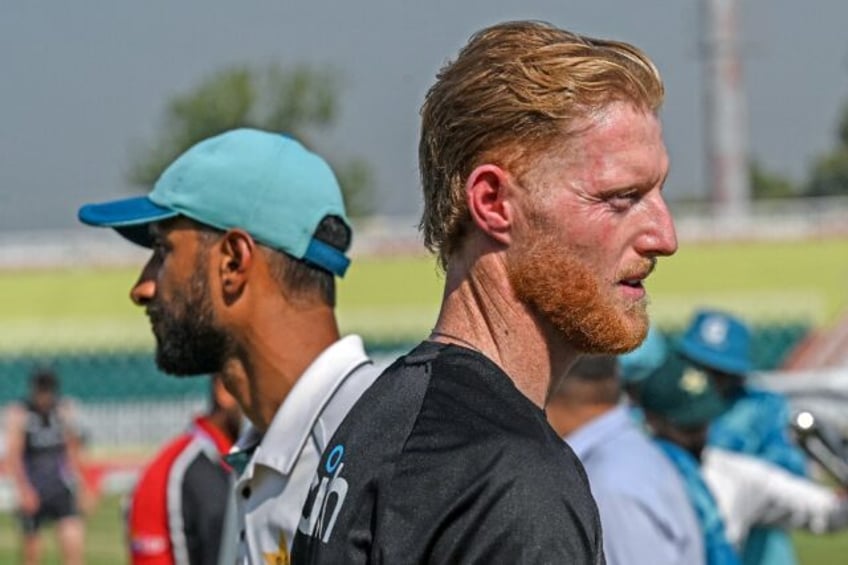 England's captain Ben Stokes and his Pakistan's counterpart Shan Masood (L) gesture at the