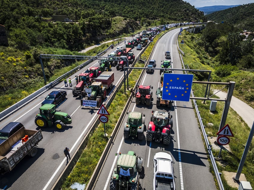 Farmers use tractors to block the AP7 highway during a protest over food security on the French-Spanish border in Le Perthus, France, on Monday, June 3, 2024. The grains industry was disrupted earlier this year during demonstrations led by French farmers highlighting rising costs, stringent regulations and cheap imports. Photographer: Angel Garcia/Bloomberg via Getty Images