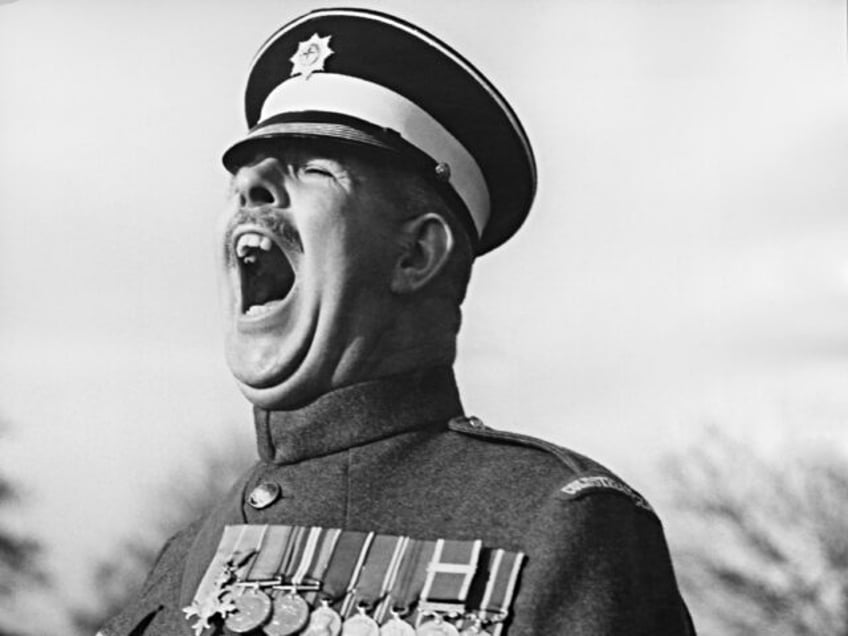 Regimental Sergeant Major Ronald Brittain (1899 - 1981) of the Coldstream Guards receives
