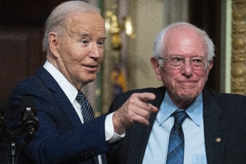 US President Joe Biden gestures as Senator Bernie Sanders, Independent from Vermont, looks