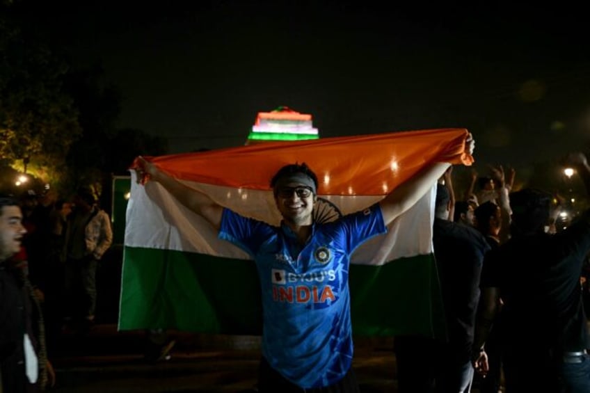 Fans celebrate near India Gate in New Delhi after India won the Champions Trophy