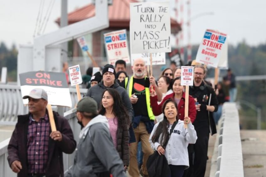 Striking workers with the International Association of Machinists and Aerospace Workers wi