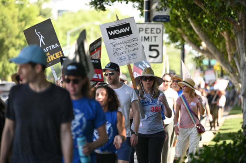 striking hollywood writers outraged over universal studios trimming trees that gave them shade in picket line