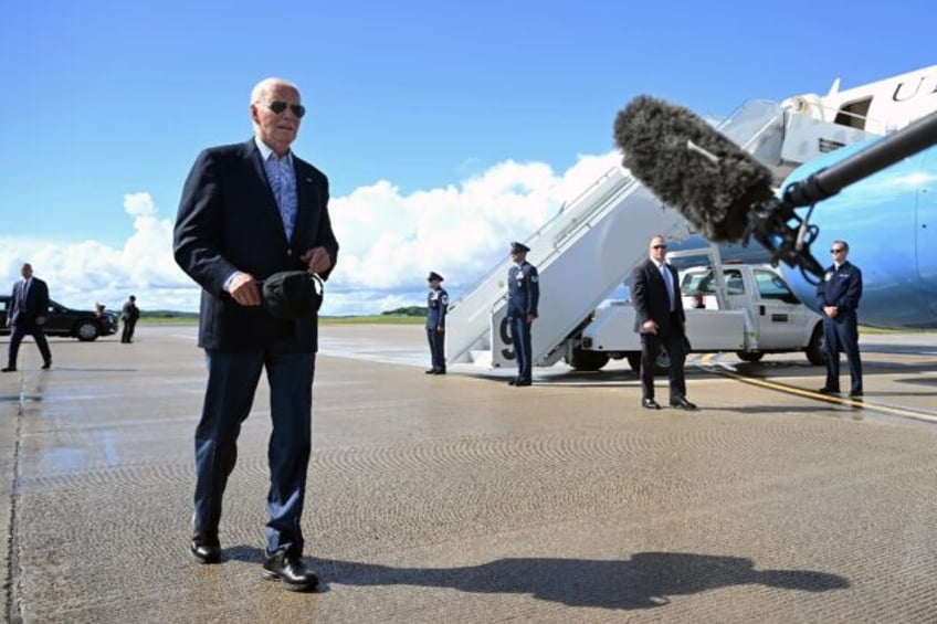 US President Joe Biden walks to speak with the press before boarding Air Force One prior t