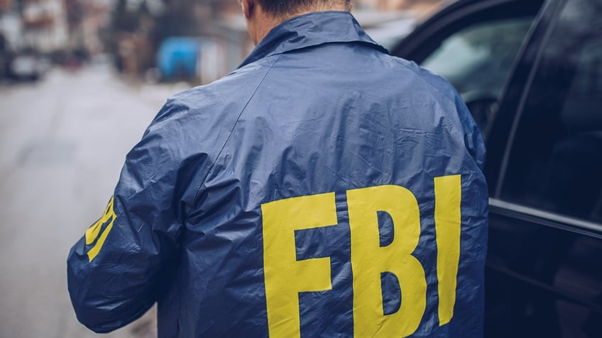 Male FBI agent seen in photo wearing FBI jacket