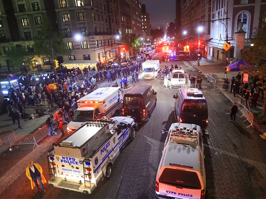 New York Police Department officers detain dozens of pro-Palestinian students at Columbia University after they barricaded themselves at the Hamilton Hall building near Gaza Solidarity Encampment earlier in New York, United States on April 30, 2024. (Photo by Selcuk Acar/Anadolu via Getty Images)