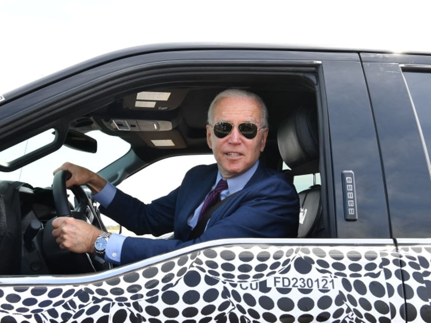 TOPSHOT - US President Joe Biden drives the new electric Ford F-150 Lightning at the Ford Dearborn Development Center in Dearborn, Michigan on May 18, 2021. (Photo by Nicholas Kamm / AFP) (Photo by NICHOLAS KAMM/AFP via Getty Images)