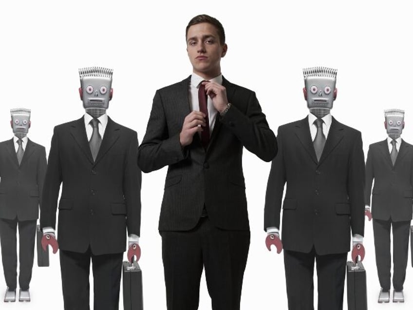 A worker in front of robot workers