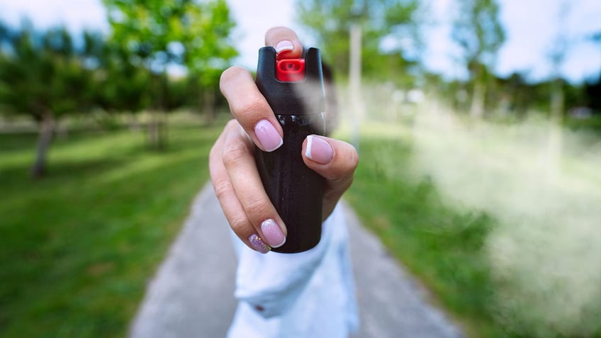 woman sprays pepper spray