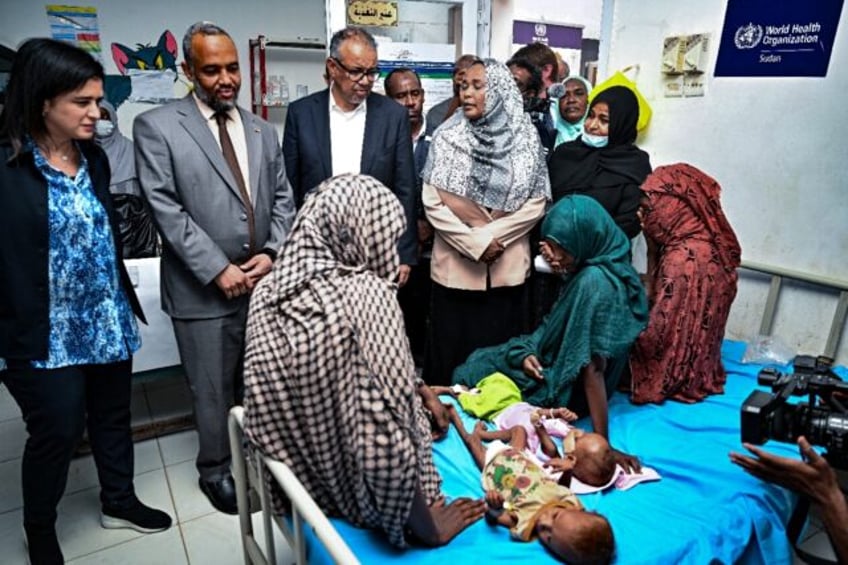 World Health Organization chief Tedros Adhanom Ghebreyesus (C) visits a children's hospit