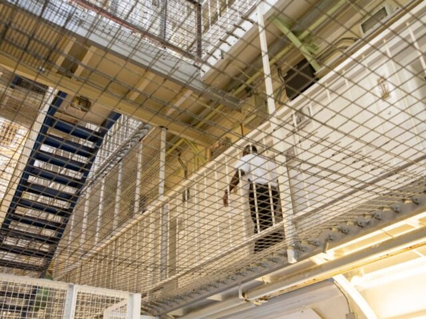 A Prison Officer walks along the landing of Her Majestys Prison Pentonville, London, Unite