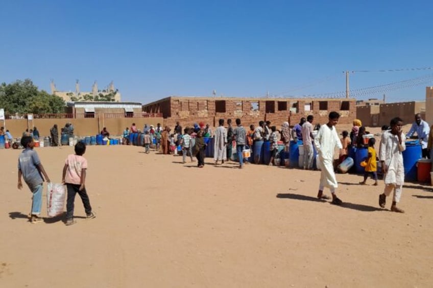 Sudanese queue for water in Omdurman, part of the greater Khartoum area where Sudan's army