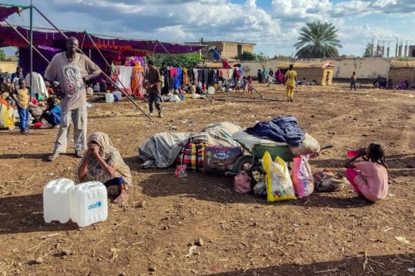 Sudanese people fleeing al-Jazira district arrive at a camp for the displaced in the easte