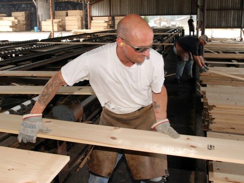 In this April 25, 2013 file photo, Jeff Lauderdale sorts pine lumber at the Rough & Re