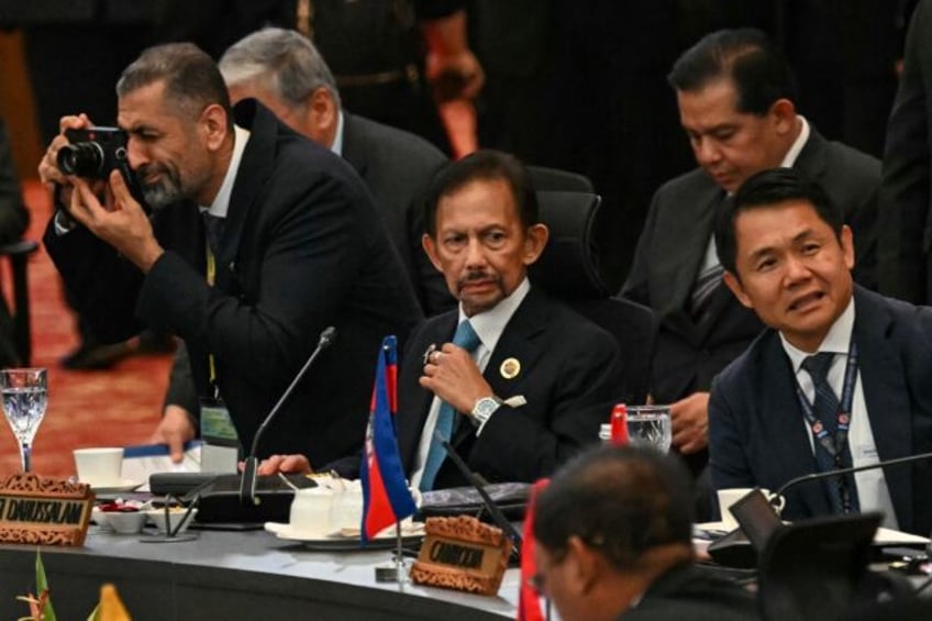 Sultan of Brunei Hassanal Bolkiah (C) descends from a family that ruled Brunei for more th