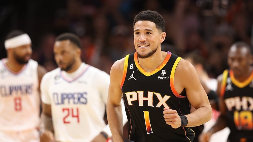 Devin Booker smiles on court