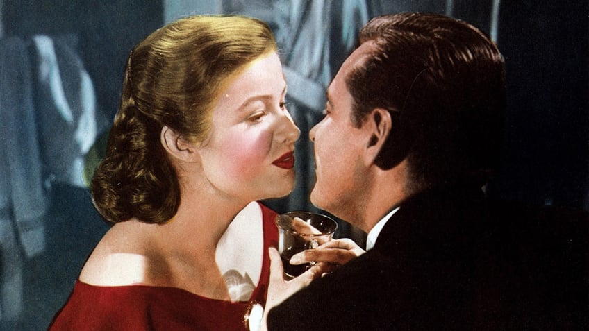 Nancy Olson Livingston and William Holden sharing a kiss