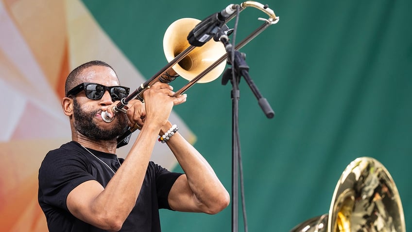 Trombone Shorty playing at the 2024 New Orleans Jazz & Heritage Festival