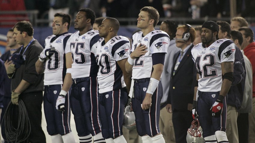 Patriots players stand for the anthem