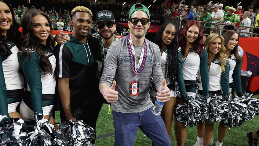 Pete Davidson posing with cheerleaders at the Super Bowl.