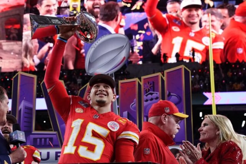 Kansas City Chiefs' quarterback Patrick Mahomes celebrates with the trophy after the Chief