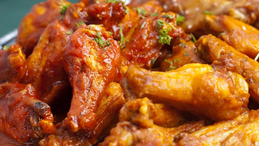 A closeup look of spicy chicken wings on a platter.