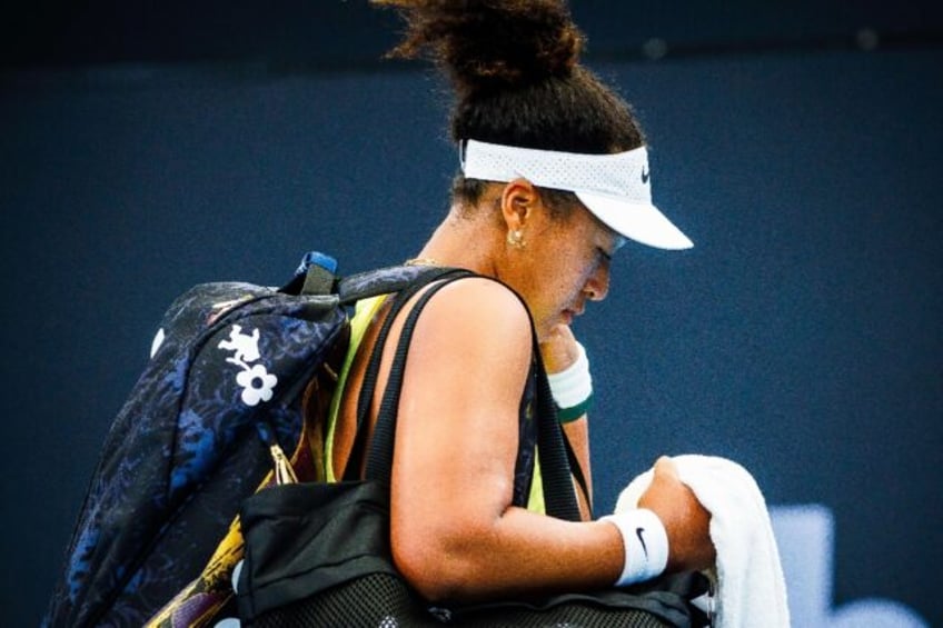 Naomi Osaka leaves the court in Brisbane after losing hersingles match against Karolina Pliskova