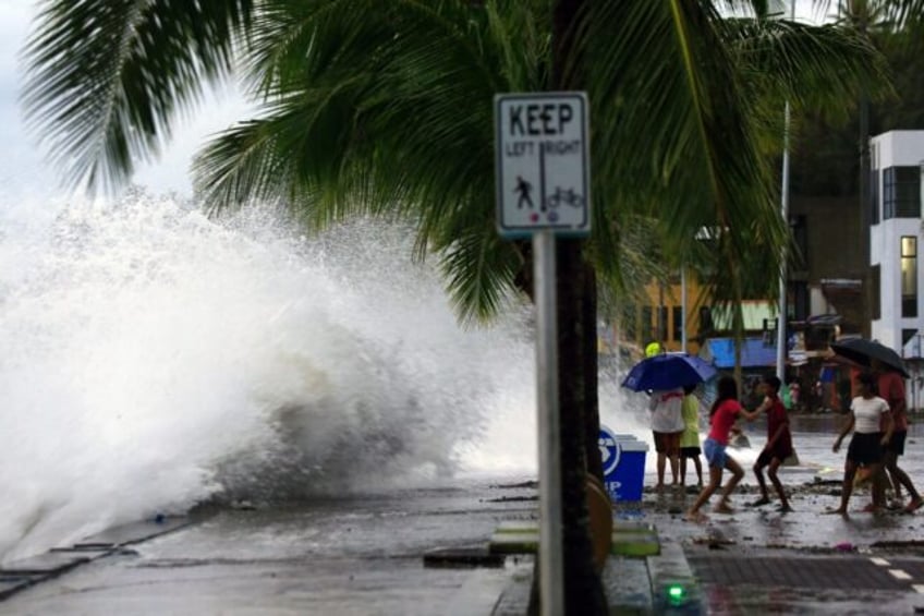 Large waves break along a seawall ahead of the expected landfall of Super Typhoon Man-yi i