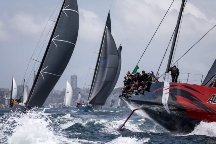 Favourite Andoo Comanche (R) competes during the start of the annual Sydney to Hobart yach