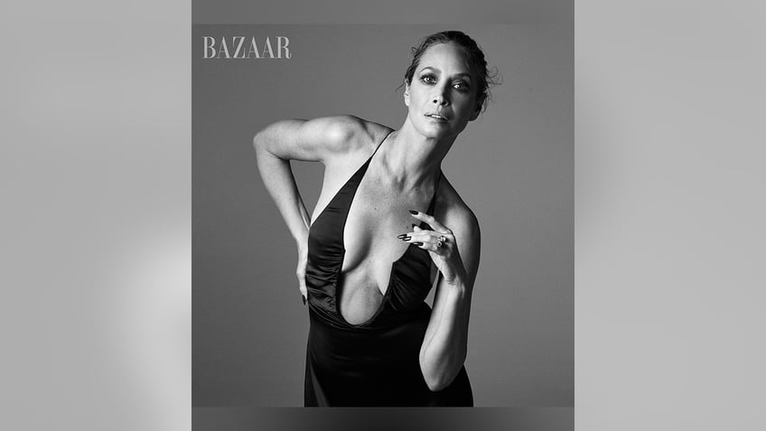 Christy Turlington models a plunging top in a black and white photo for Harper's Bazaar