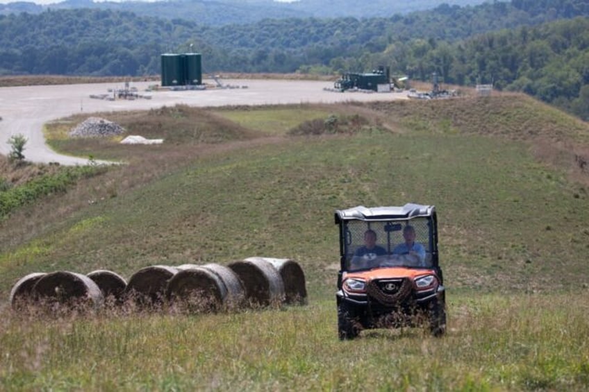 Diana Petrie, left, and her father George Wherry drive through hay fields after giving a t