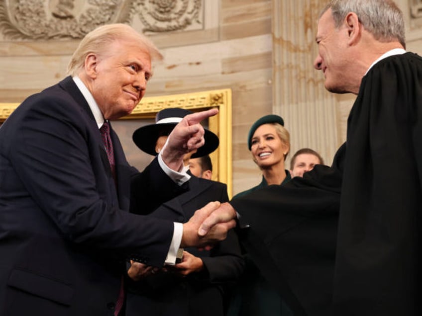 US President Donald Trump and John Roberts, chief justice of the US Supreme Court, shake h