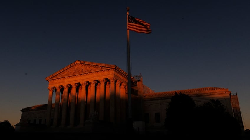 Supreme Court building tinted red from sunset 