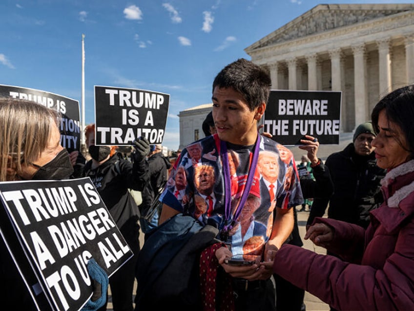 Gabriel Chambers (C), a supporter of former US President Donald Trump, speaks anti-Trump d