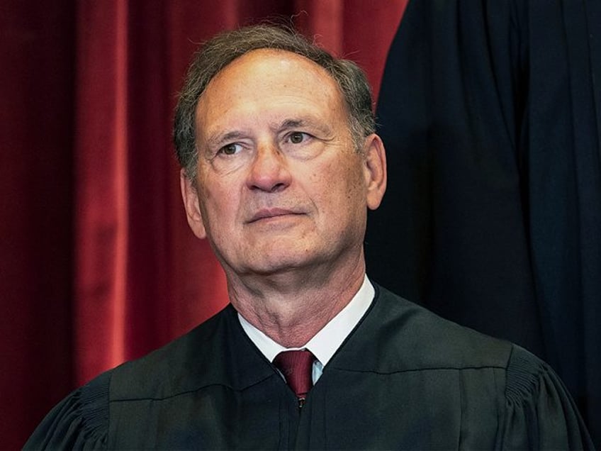 Associate Justice Samuel Alito sits during a group photo at the Supreme Court in Washingto