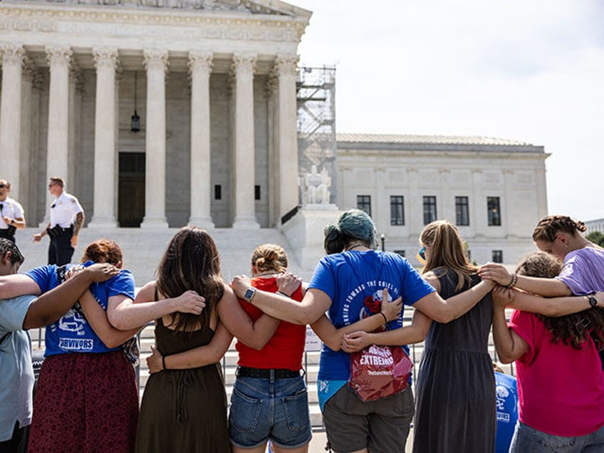 Anti-abortion demonstrators pray in front of the Supreme Court on June 26, 2024 in Washing