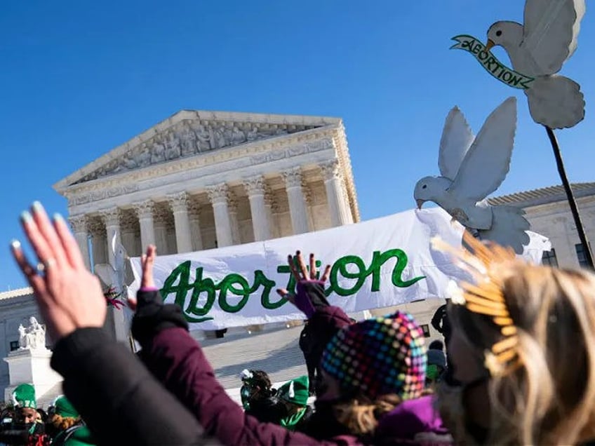 Pro-choice activists participate in a "flash-mob" demonstration outside of the US Supreme