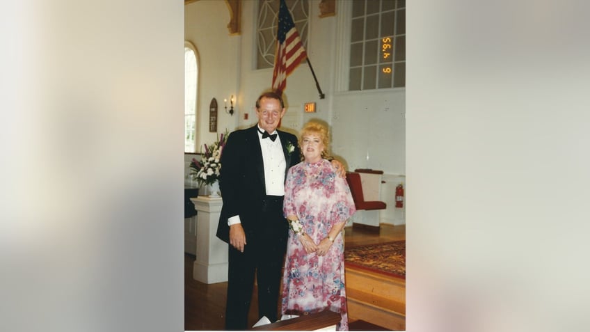 Barbara Mabee Abel in a pink floral dress with Jim Abel in a suit and bowtie