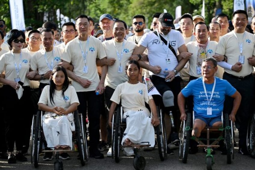 Survivors and sniffing dogs joined hundreds of people at Cambodia's Angkor Wat for a march