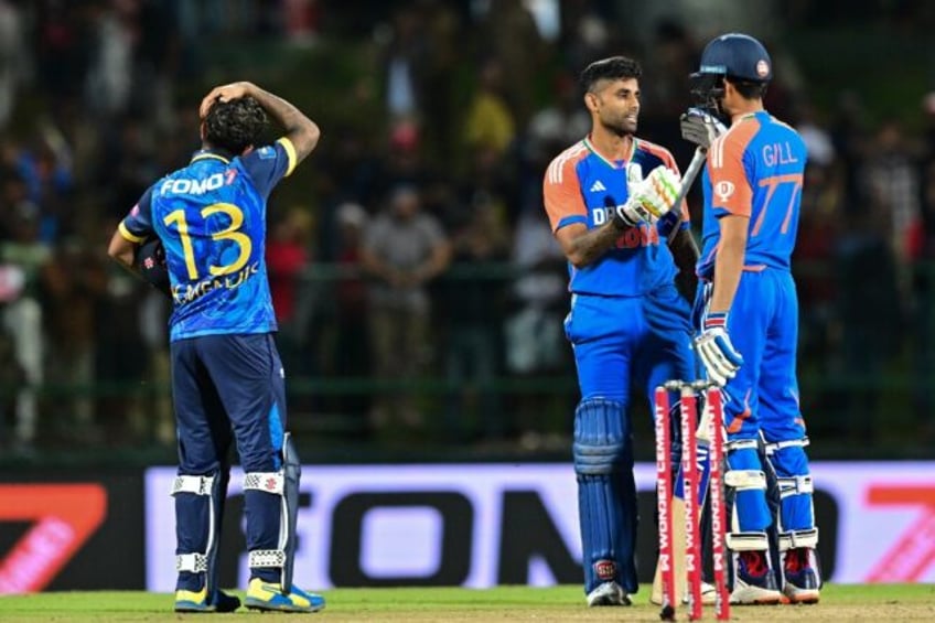 India's captain Suryakumar Yadav (C) and Shubman Gill (R) celebrate after winning the supe