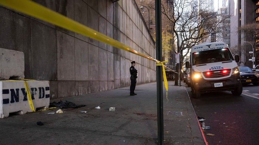 Law enforcement officials work at the site of a stabbing spree near the United Nations Headquarters in New York, Monday.