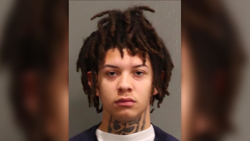 Cameron has dreadlocks and a neck tattoo in his mugshot
