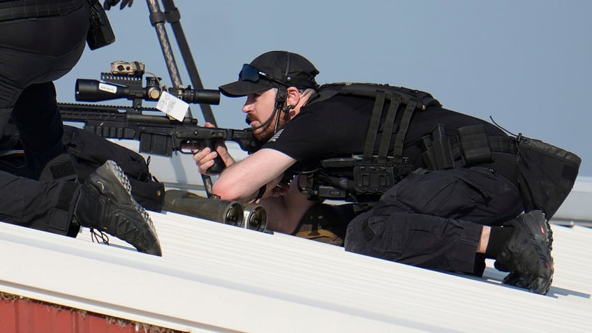 Police snipers return fire after shots were fired while Republican presidential candidate former President Donald Trump was speaking at a campaign event