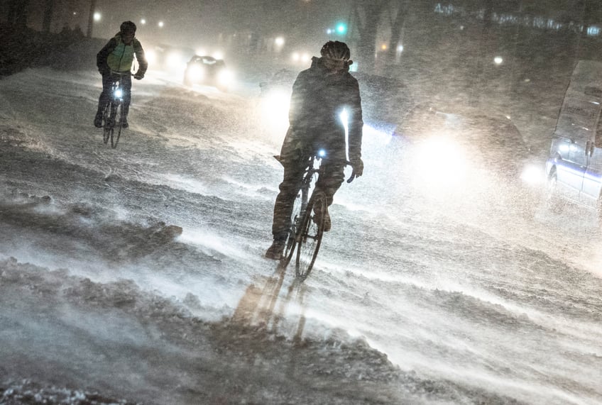 Cyclists make their way through heavy snowfall in Aalborg, northern Jutland, Denmark, on January 3, 2024. (Photo by Henning Bagger / Ritzau Scanpix / AFP) / Denmark OUT (Photo by HENNING BAGGER/Ritzau Scanpix/AFP via Getty Images)