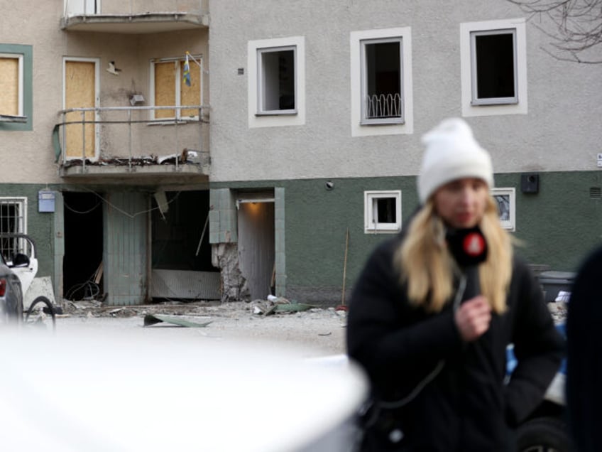 STOCKHOLM, SWEDEN - FEBRUARY 02: Members of the media stand in front a damaged block of flats after a gang-related bomb exploded early in the morning on February 02, 2024 in Sundbyberg, Sweden. Sweden has recently been in the grip of a bloody conflict between gangs fighting over arms and …