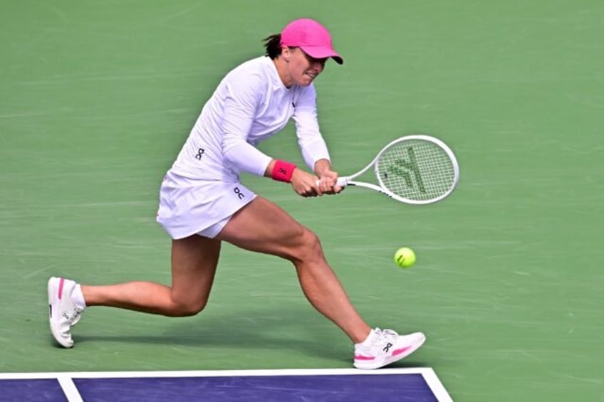 Poland's Iga Swiatek hits a backhand on the way to a quarter-final victory over Denmark's