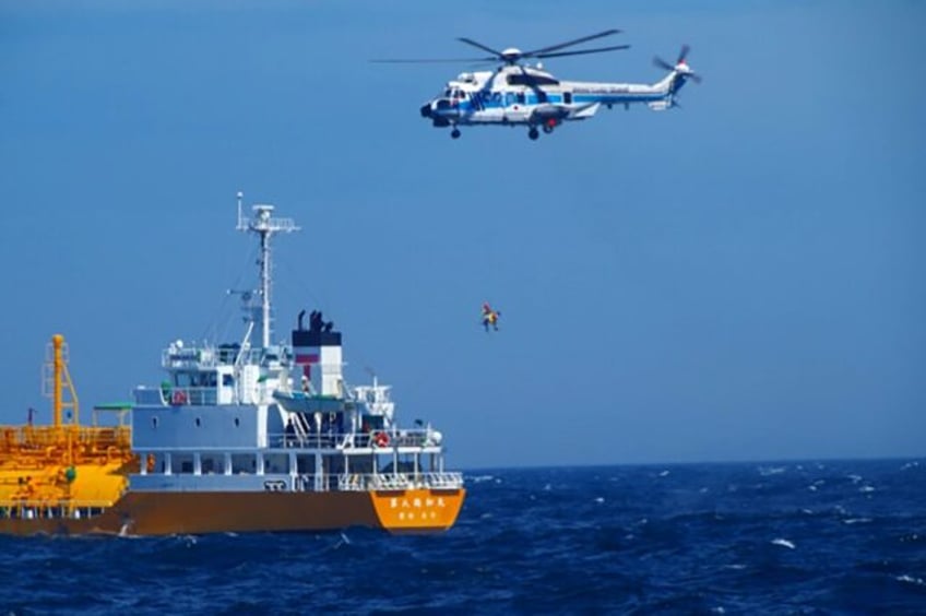 A woman who went swimming off a beach in Japan and was swept out to sea was rescued about