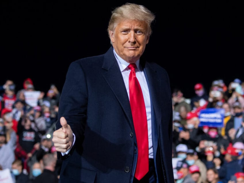 TOPSHOT - US President Donald Trump gives a thumbs up as he arrives to hold a Make America